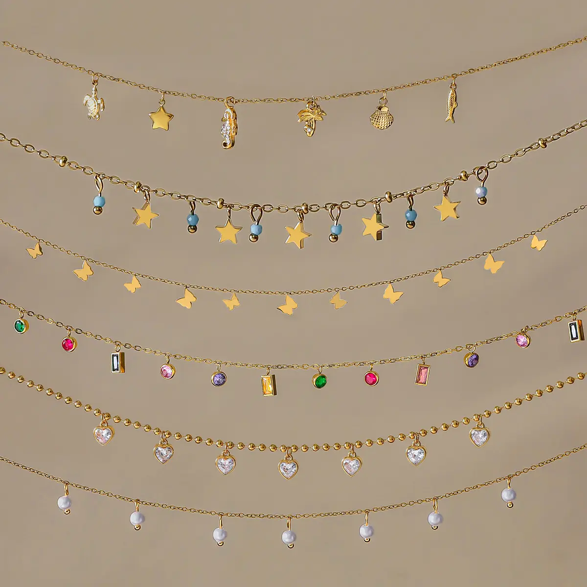 Charm necklace collection with stars, butterflies, sea-life shapes and colored stone details