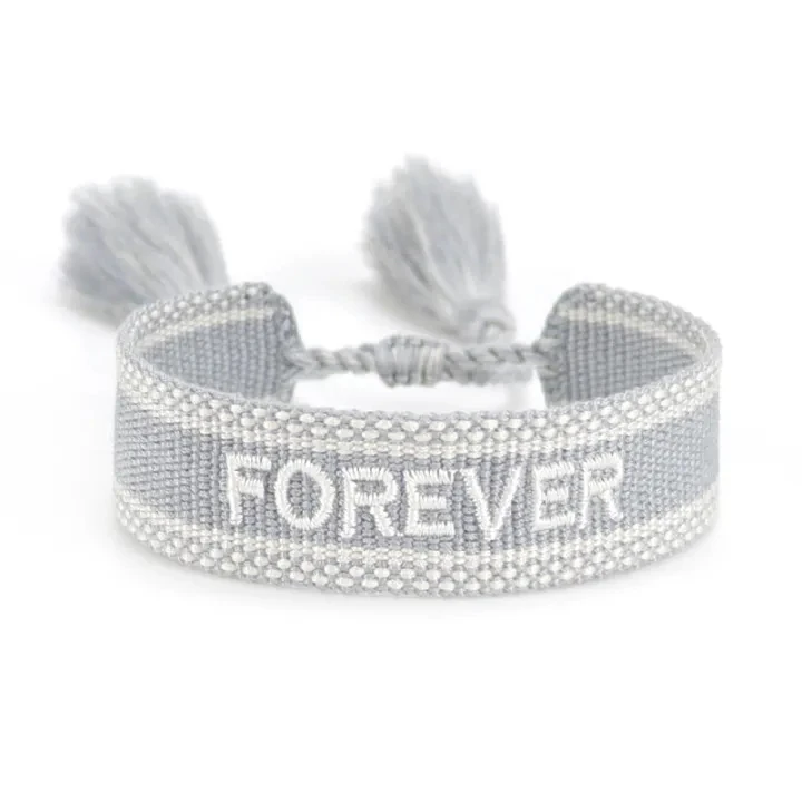 Real gray ZM39-66 woven bracelet displaying the embroidered word FOREVER in white