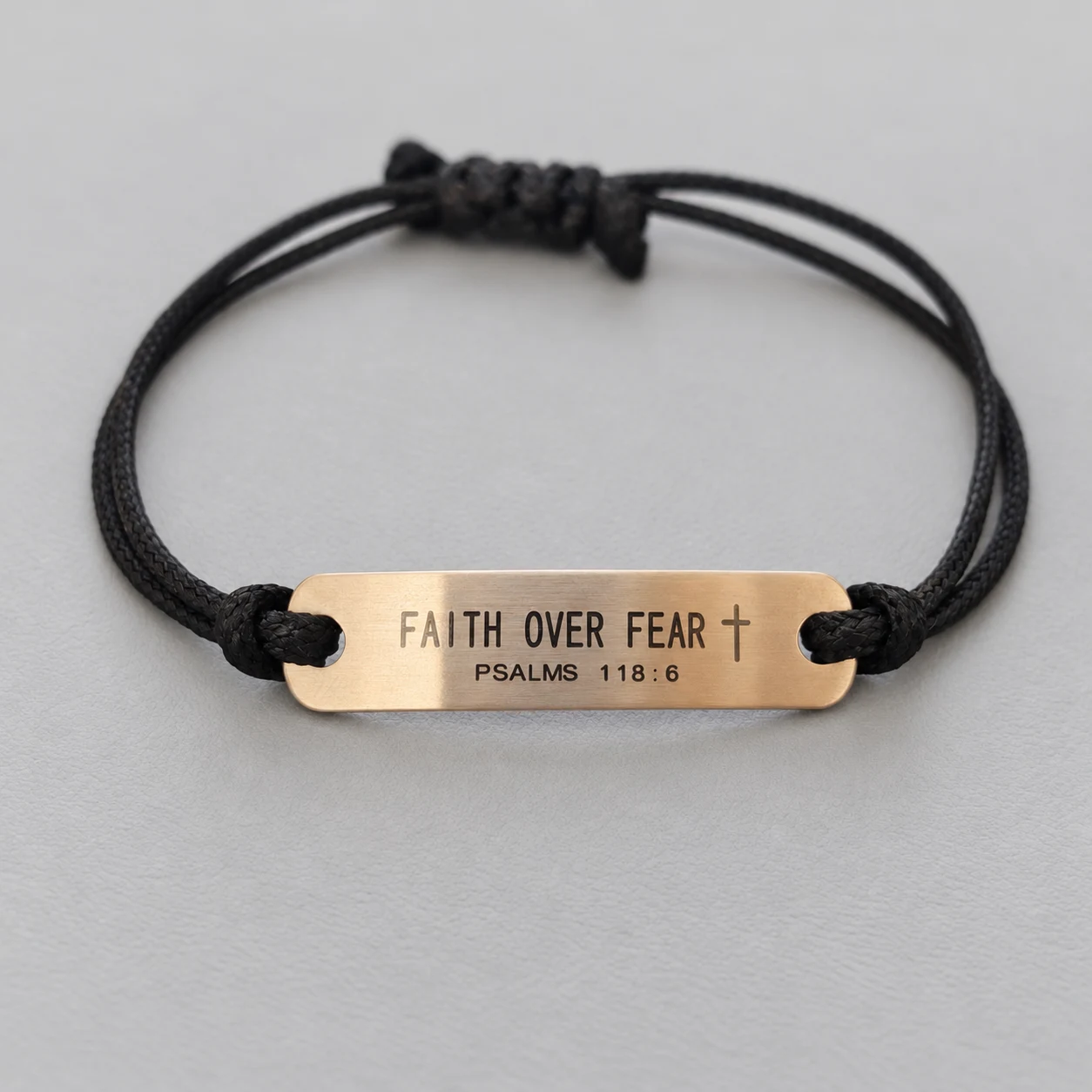 AI-assisted retouch of an actual black cord sample with a warm-tone FAITH OVER FEAR cross and PSALMS 118:6 message bar