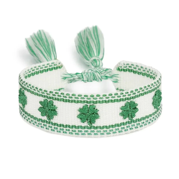 Actual ZM67-179 bracelet with green clover motifs on a light band