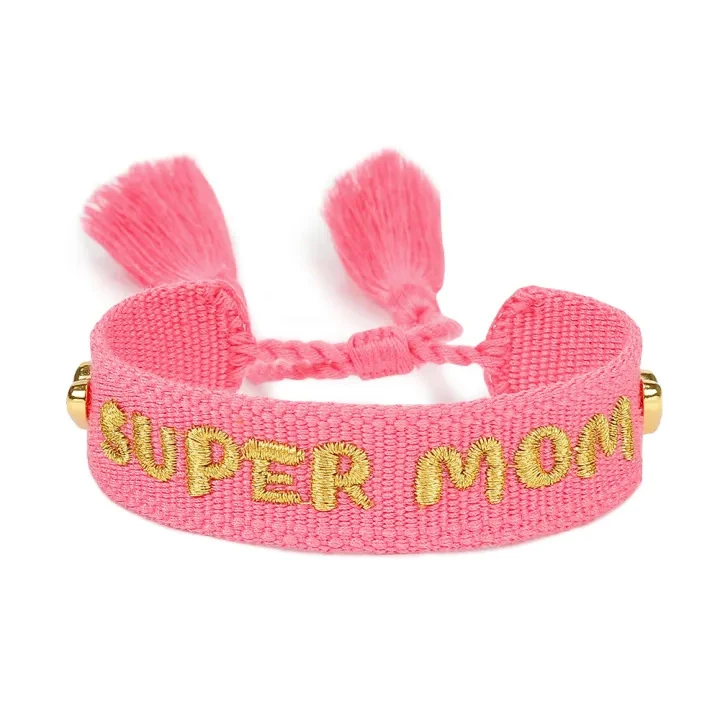 Real pink woven bracelet embroidered with the exact words SUPER MOM in gold-tone thread